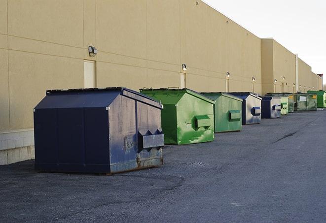 a fleet of red and blue construction dumpsters available for use in Hebron IN